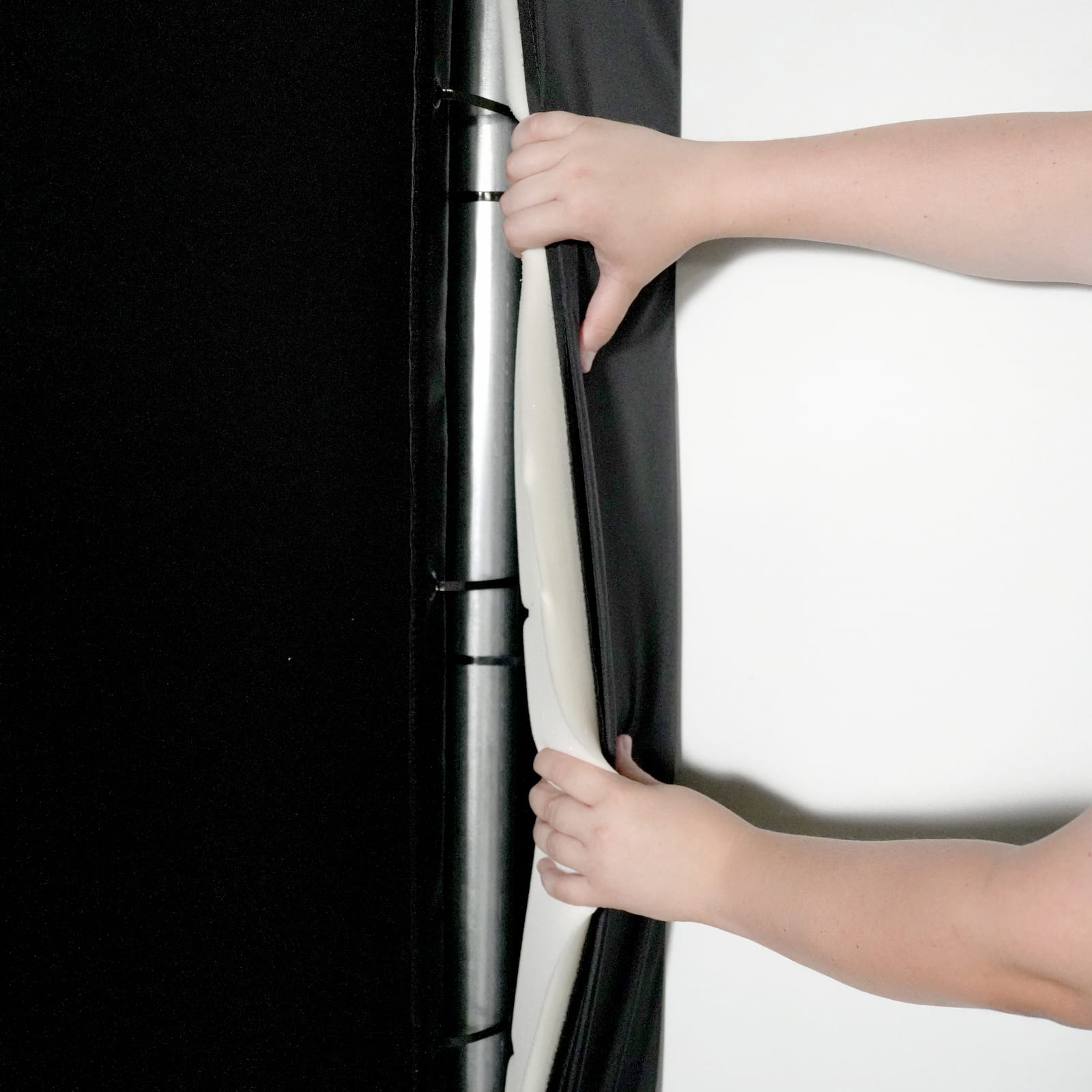 Person holding a black and white striped fabric panel