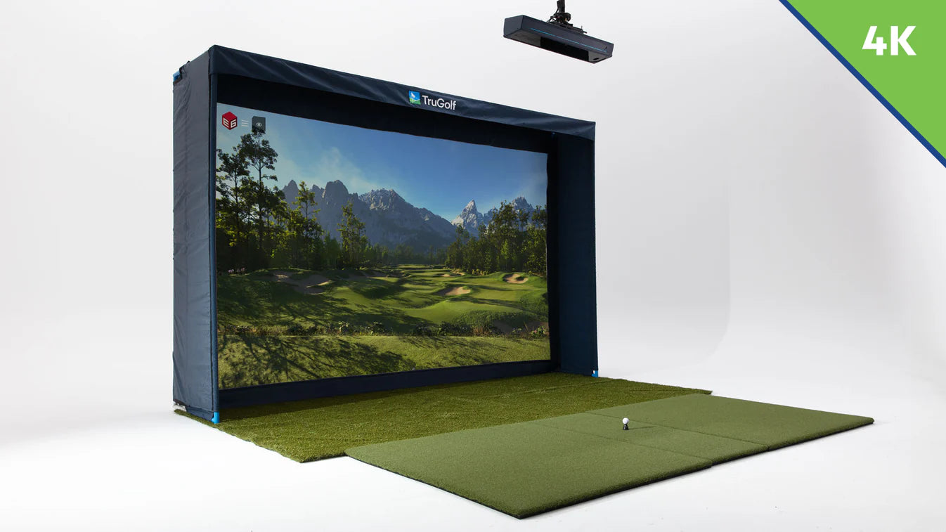 Golf simulator with screen displaying a golf course and mountains, on a white background.